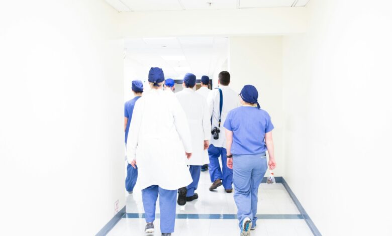 group of doctors walking on hospital hallway